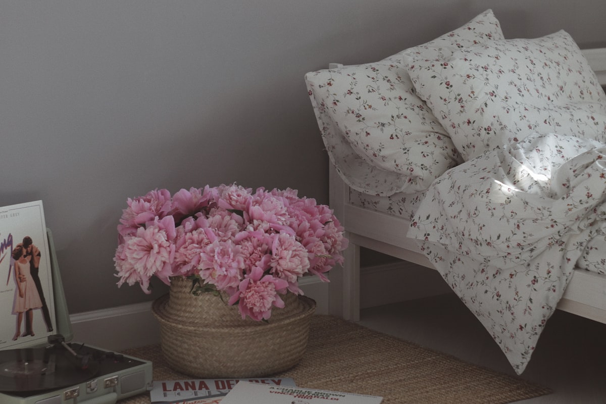 pink flowers on brown woven basket related to Elevate Your Bedroom with Shabby Chic Bedding