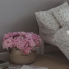 pink flowers on brown woven basket related to Elevate Your Bedroom with Shabby Chic Bedding
