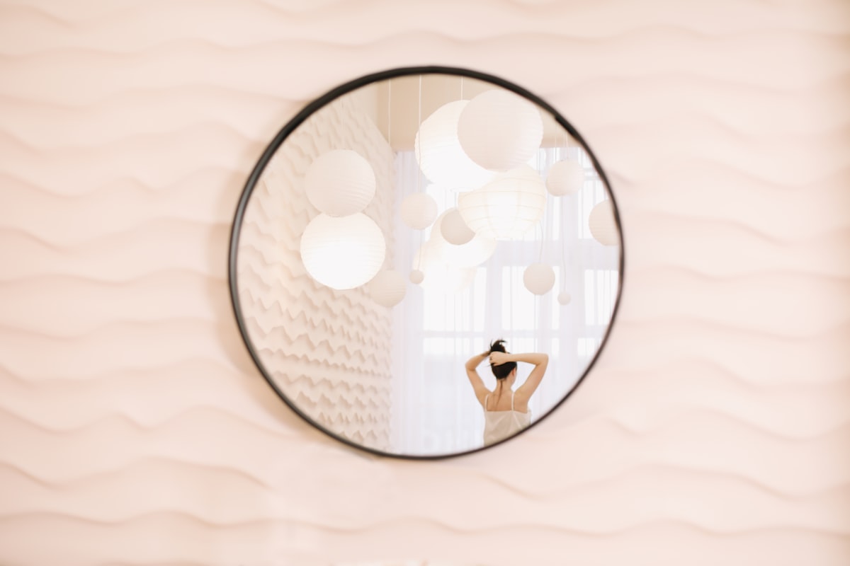 Portrait of calm pretty girl. Portrait of the woman reflected in mirror in a cozy light room in the morning. related to Elegant Mirror Images: 3 Captivating Mirrored Buffet Sideboard Designs