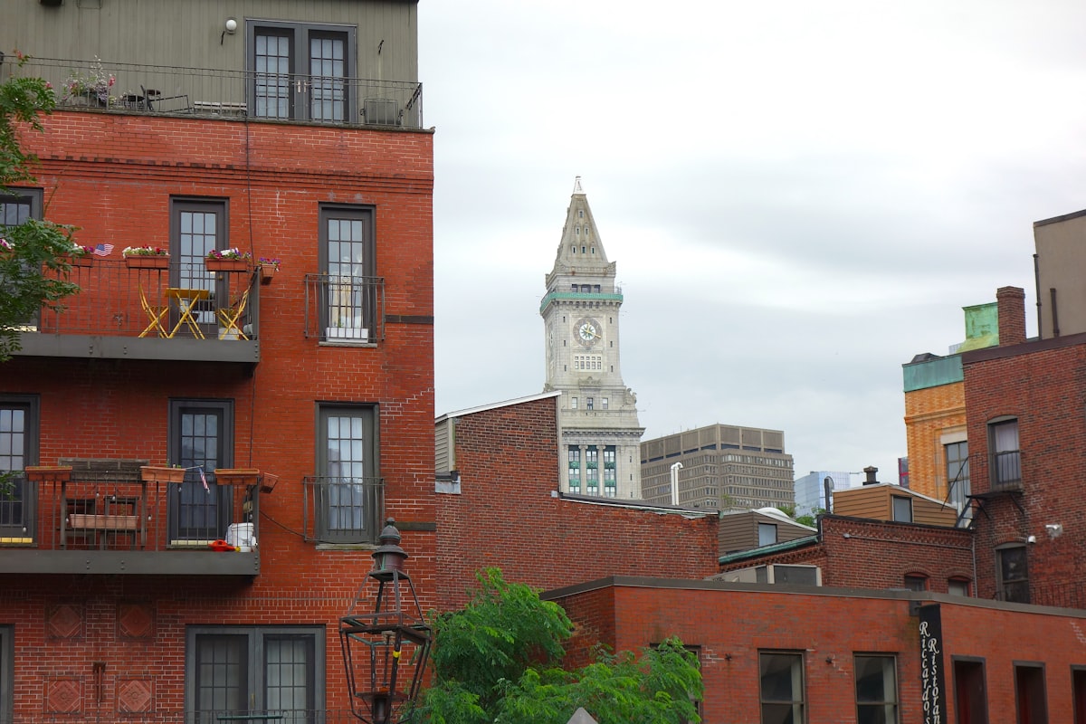 Red brick buildings with a clock tower in boston. related to Top Bed and Breakfasts in Boston, MA: Where Comfort Meets Charm