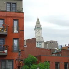 Red brick buildings with a clock tower in boston. related to Top Bed and Breakfasts in Boston, MA: Where Comfort Meets Charm