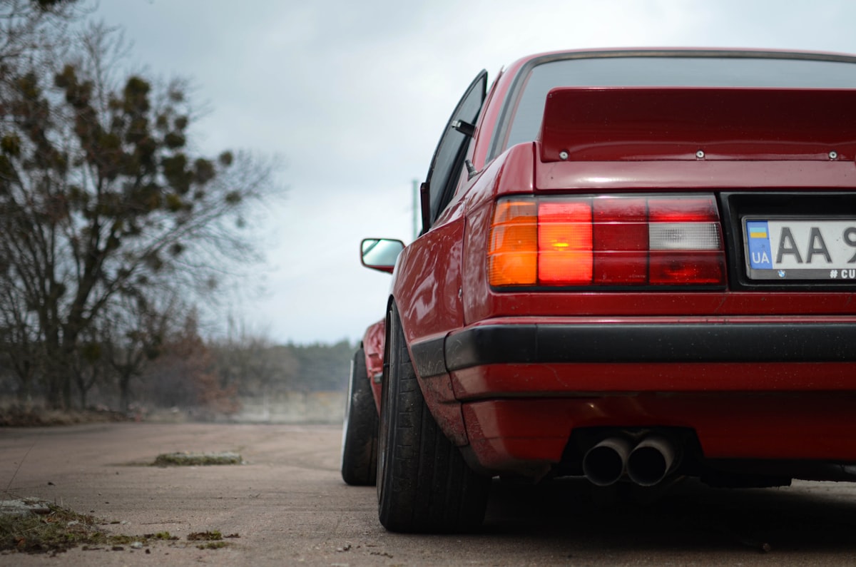 red car on gray asphalt road during daytime related to E30 Rear Valance: Upgrade Your BMW's Aesthetics