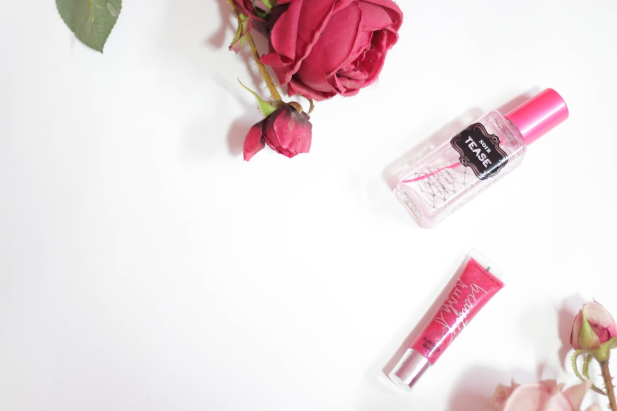 red rose beside clear perfume bottle related to Snuggle & Dream: Discover the Beauty of Coral Crib Bedding
