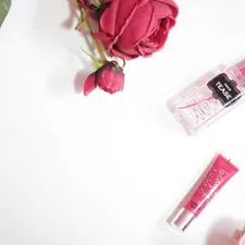 red rose beside clear perfume bottle related to Snuggle & Dream: Discover the Beauty of Coral Crib Bedding