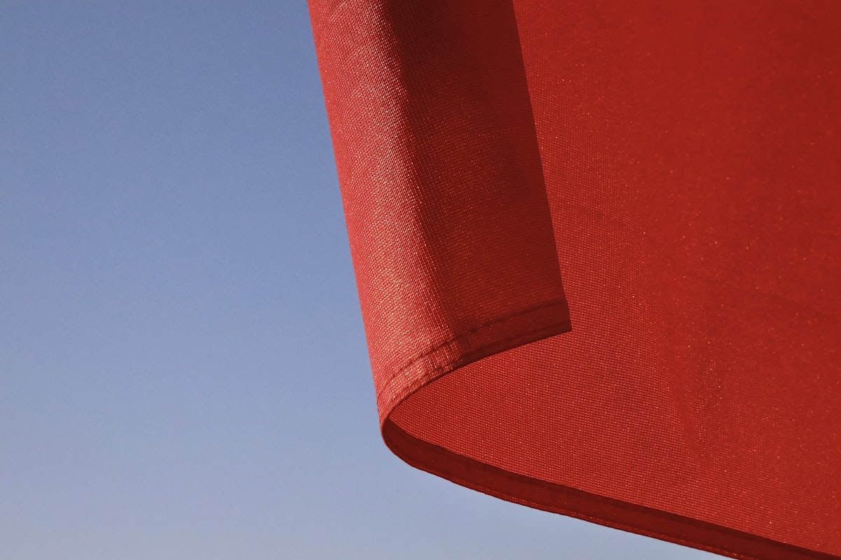 red textile under blue sky during daytime related to Elevate Your Home Decor: Solid Red Curtain Valance Ideas