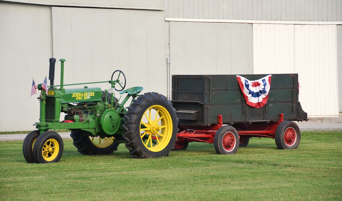 Restored Historic John Deere Tractor with vintage trailer with USA Flags and bunting related to Ultimate Kids' Bedroom Design with a Tractor-Inspired Bed