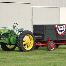 Restored Historic John Deere Tractor with vintage trailer with USA Flags and bunting related to Ultimate Kids' Bedroom Design with a Tractor-Inspired Bed