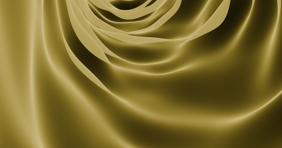 Rich golden, satin-like folds forming soft waves and layered curves — a luxurious widescreen abstract background ideal for premium branding, packaging mockups, and elegant presentations. related to Experience the Unbeatable Luxury of Gold Bed Comforters