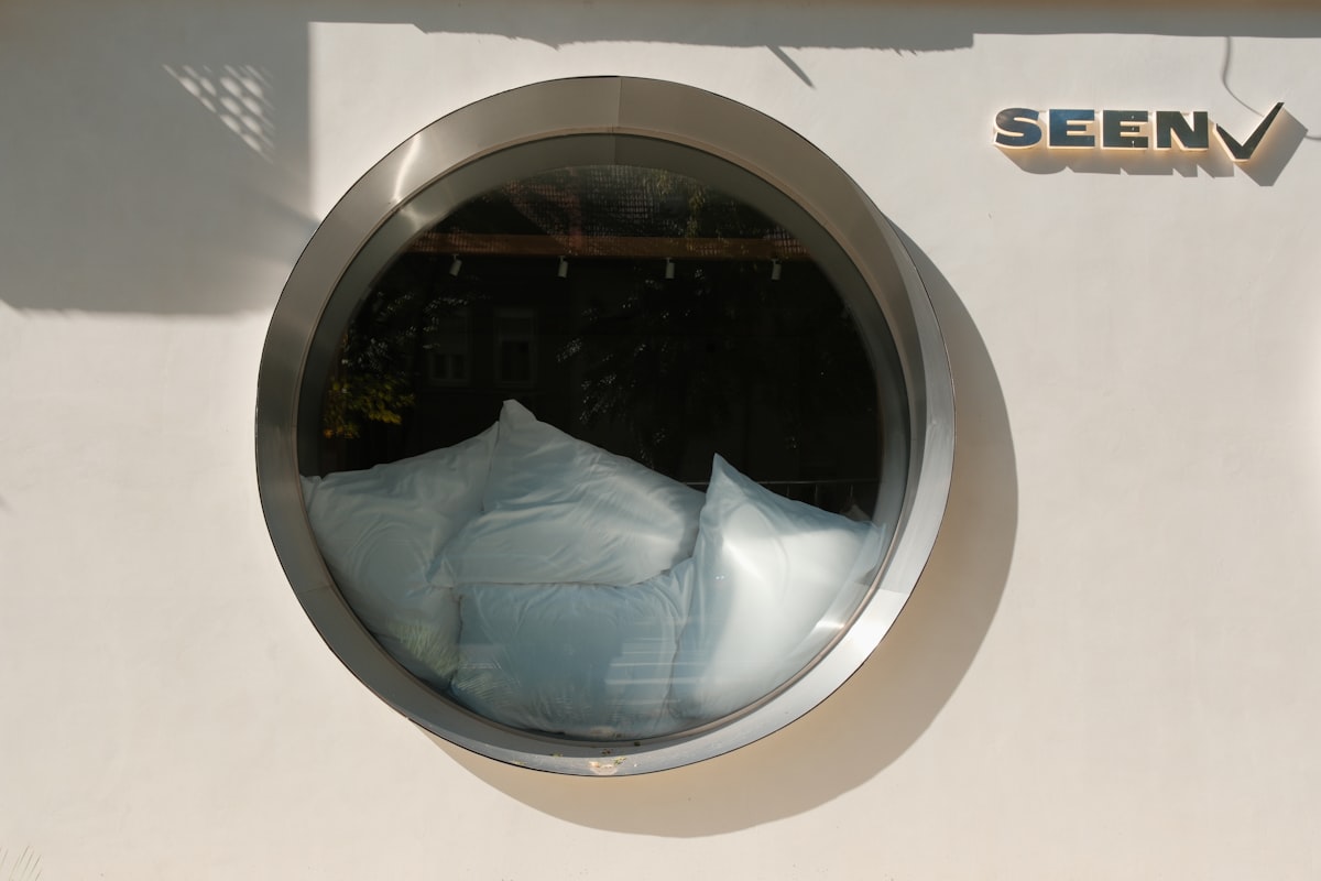 Round window reflecting white abstract shapes related to Sears Bed in a Bag: The Ultimate Bedding Solution for Every Home