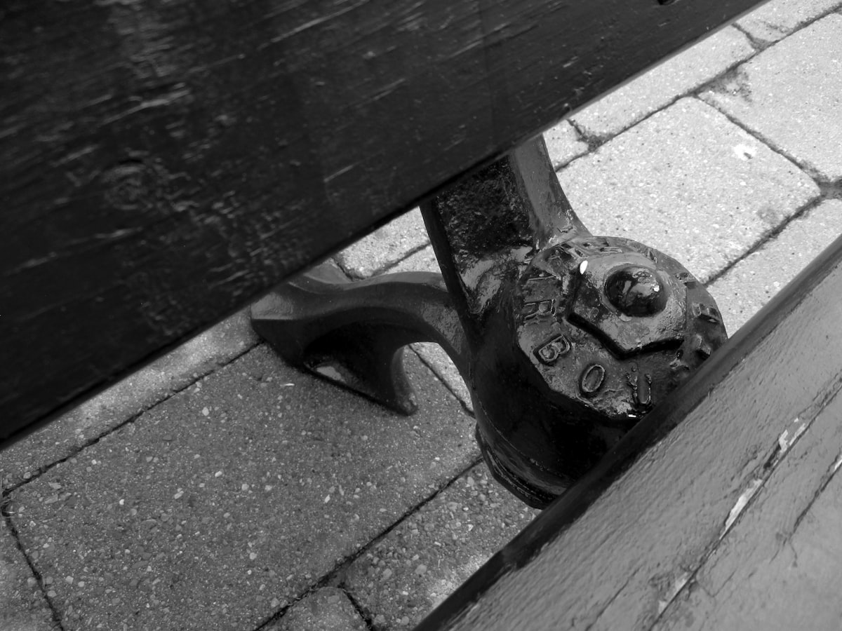 Rustic park bench support in black and white. related to Enhance Your Bedroom with a Stylish Foot of the Bed Bench