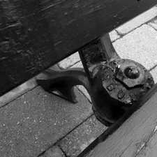 Rustic park bench support in black and white. related to Enhance Your Bedroom with a Stylish Foot of the Bed Bench