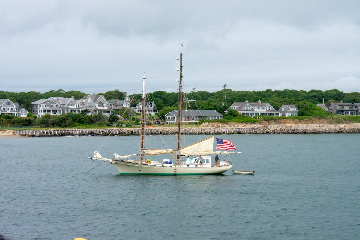 Sailboat anchored near the shoreline on Martha's Vineyard. related to Discover the Charm of Cozy Inns in New England