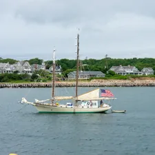 Sailboat anchored near the shoreline on Martha's Vineyard. related to Discover the Charm of Cozy Inns in New England