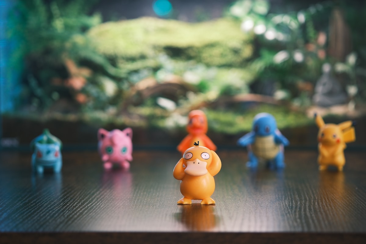 Several pokemon figures arranged on a wooden surface. related to Transform Your Child's Room with a Pokemon Bed Set