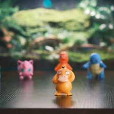 Several pokemon figures arranged on a wooden surface. related to Transform Your Child's Room with a Pokemon Bed Set