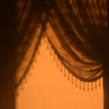 Shadows cast by draped curtains with beaded trim. related to Curtains, Valances, and Swags