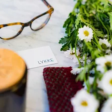 shallow focus photo of eyeglasses beside flower related to Elevate Your Style with Floral Valances for Windows