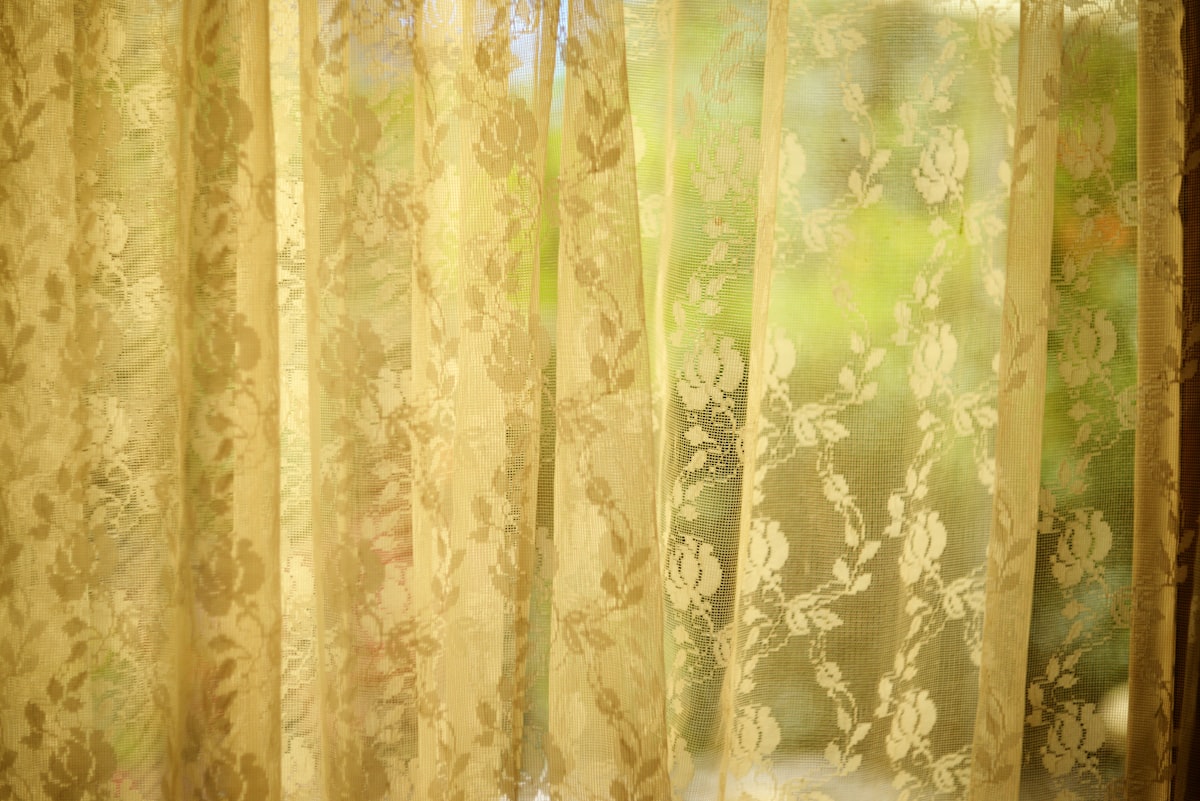 Sheer curtains softly filter the sunlight. related to Lace Curtain Panels with Attached Valance