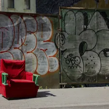 Side street in Budapest in 2015, with chair and wall of graffiti. related to The Ultimate Space Saver: Foam Chair Fold Out Bed