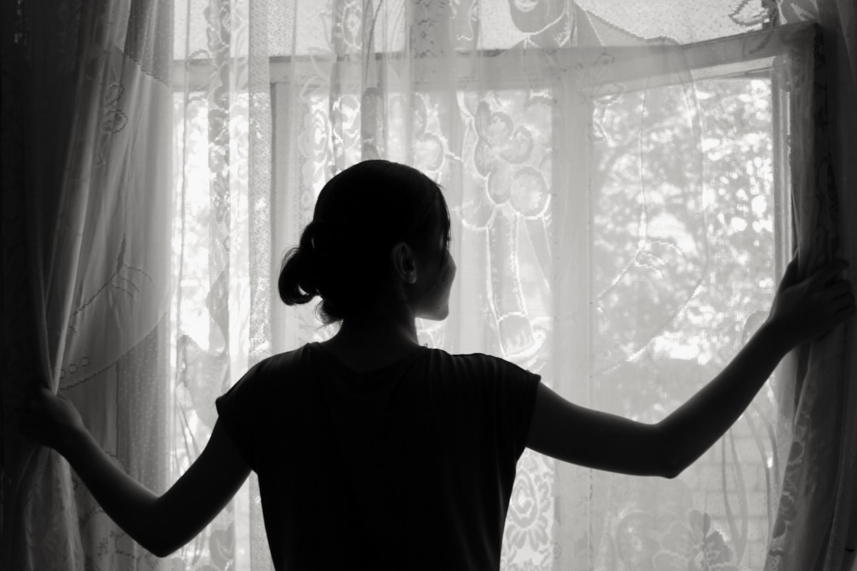 silhouette of woman opening window related to Girls Window Valance Ideas and Options