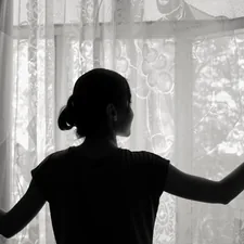 silhouette of woman opening window related to Girls Window Valance Ideas and Options