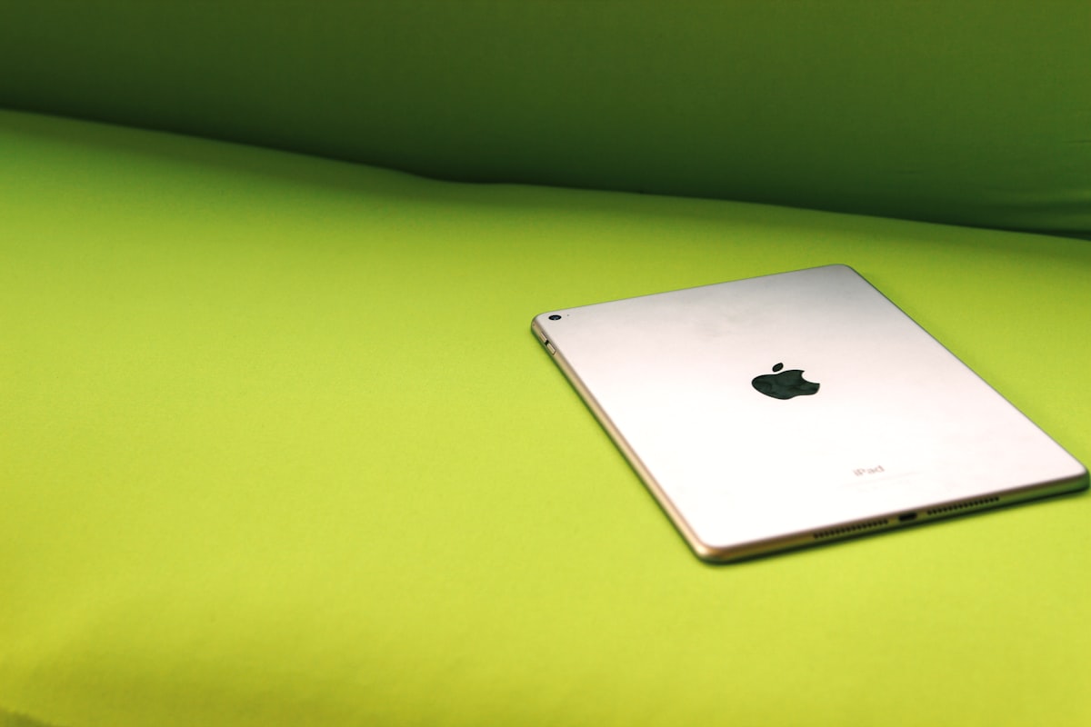 silver iPad on green surface related to Mint Green Coverlet