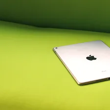 silver iPad on green surface related to Mint Green Coverlet