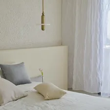 Simple aesthetic in minimalist bedroom with white sheer curtains. related to Elevate Your Home with Linen Valances: Stylish Window Treatments