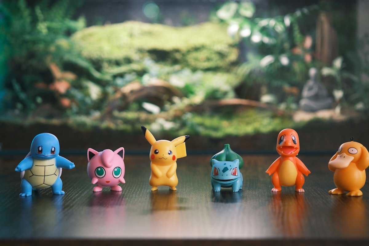 Six pokemon figurines lined up on a wooden surface. related to Transform Your Child's Room with a Pokemon Bed Set