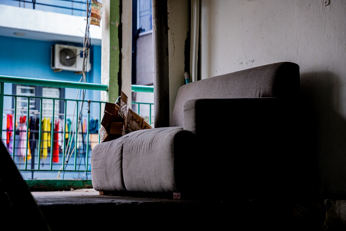 Sofa in a dimly lit room with balcony view related to Ultimate Guide to the Best Sofa Bed: Features, Options, and Reviews