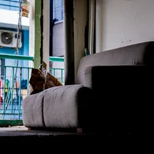 Sofa in a dimly lit room with balcony view related to Ultimate Guide to the Best Sofa Bed: Features, Options, and Reviews