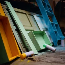 Some drawers and a bookshelf are being painted for reuse related to 10 Unique Painted Sideboards and Buffets to Elevate Your Home Decor