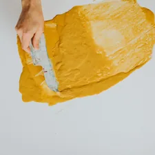 spreading yellow paint on a white canvas. Acrylic pour. Redding local artist @artofdawn related to Latex-Free Coverlet Adhesive Dressings for Sensitive Skin