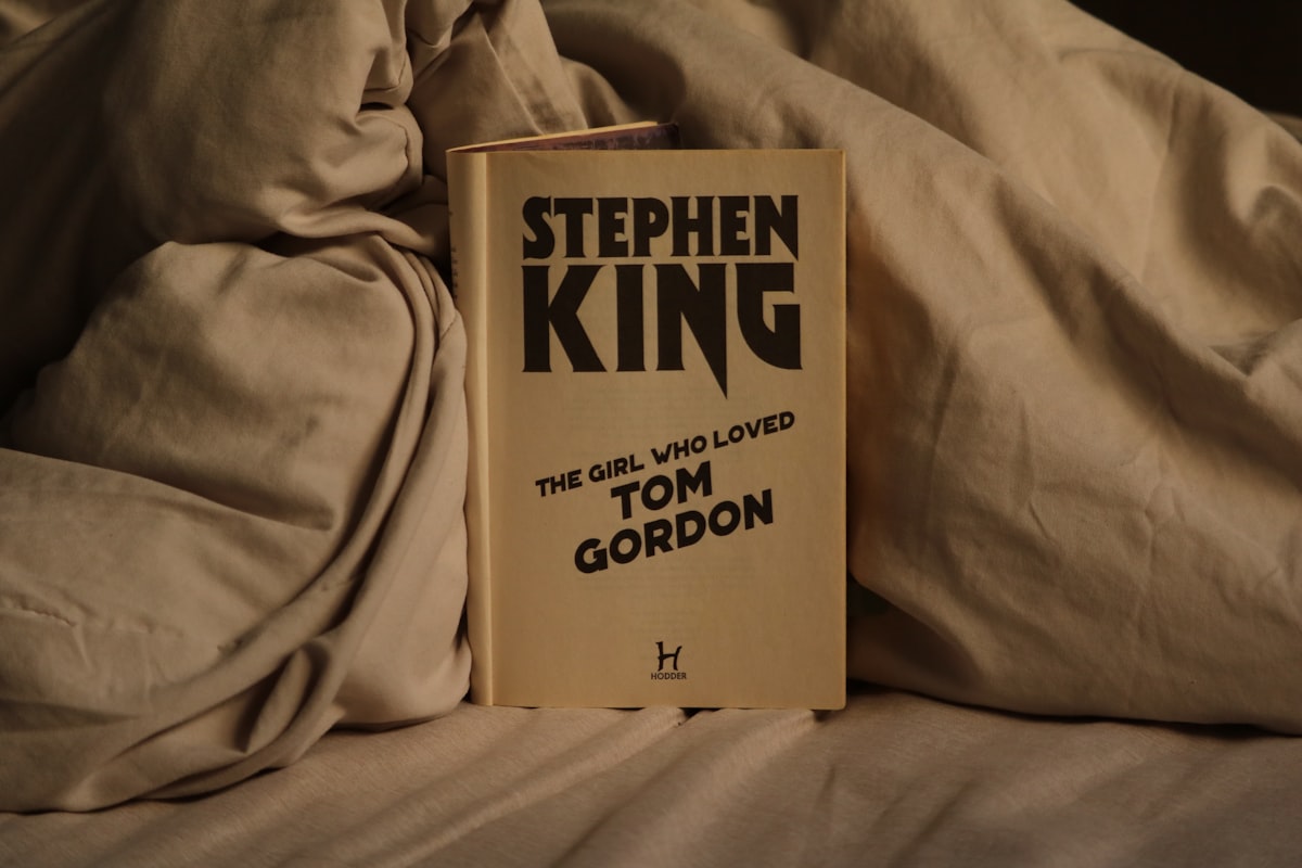 Stephen king book rests on rumpled sheets. related to Ethan Allen King Beds: The Ultimate Sleep Experience