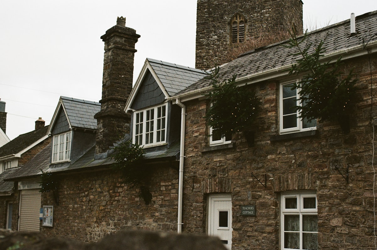 Stone cottages with a church tower in the background related to Embrace Rustic Charm: The Allure of Stone Cottage Bedding