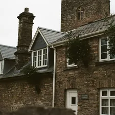 Stone cottages with a church tower in the background related to Embrace Rustic Charm: The Allure of Stone Cottage Bedding
