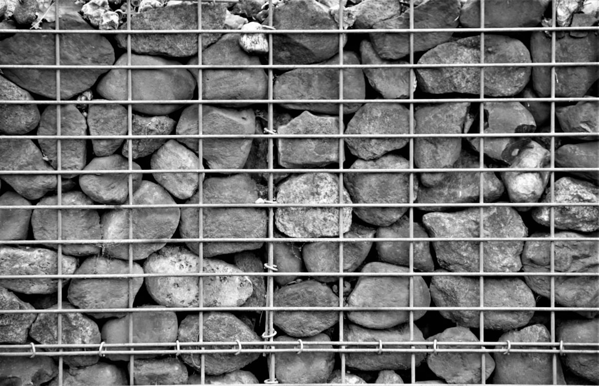 Stone Wall behind a garden fence related to The Warmth of the Rockies: The Ultimate Guide to Colorado Steel Chimineas