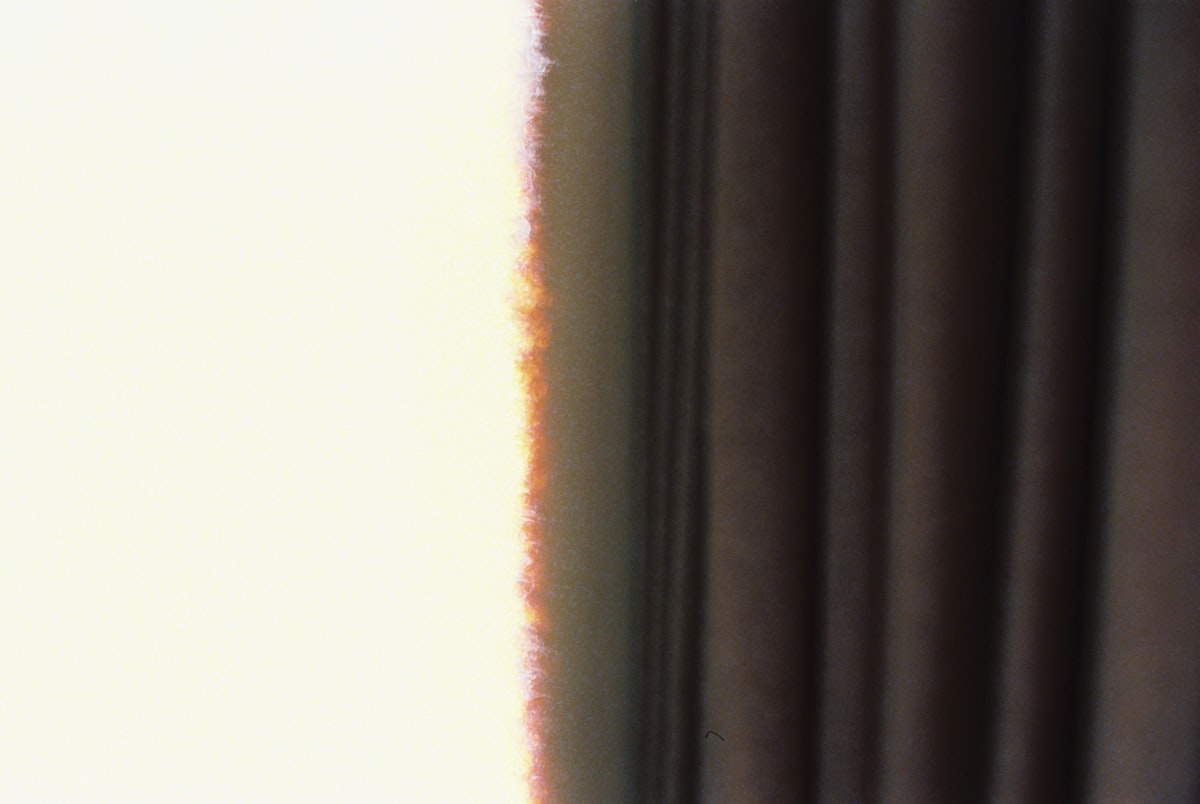 Sunlight filtering through dark curtains related to Chocolate Brown Valance Curtains