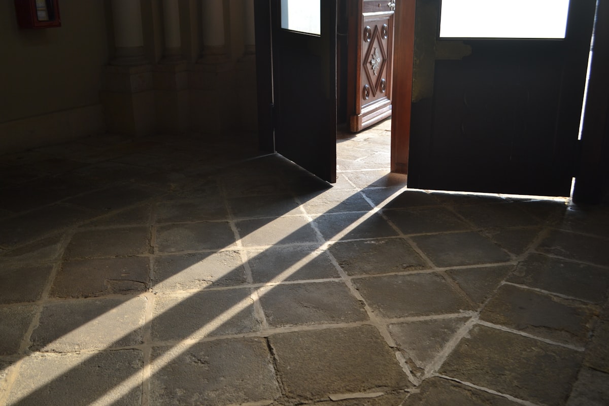 Sunlight streams across a tiled floor through open doors. related to Timeless Elegance: Elevating Your Home with Slate Tile Entryway