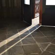 Sunlight streams across a tiled floor through open doors. related to Timeless Elegance: Elevating Your Home with Slate Tile Entryway