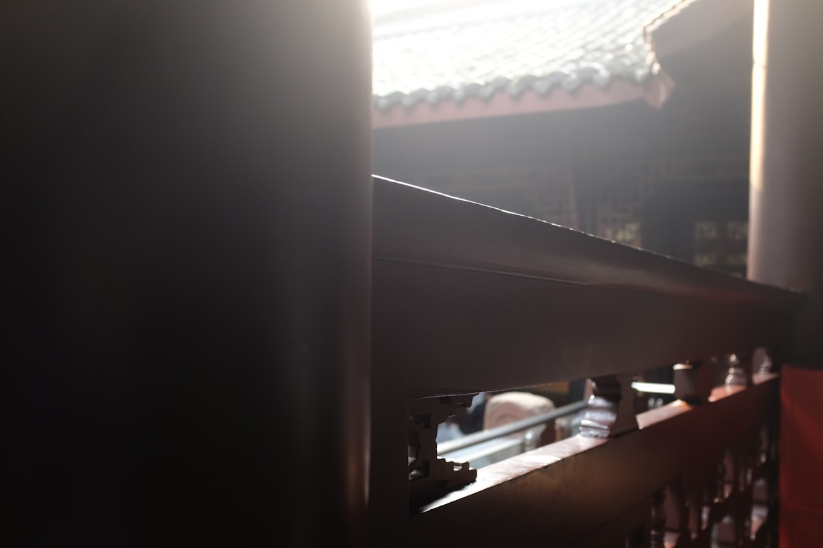 Sunlight streams through ornate wooden architecture related to Adding Warmth with a Dark Brown Sideboard