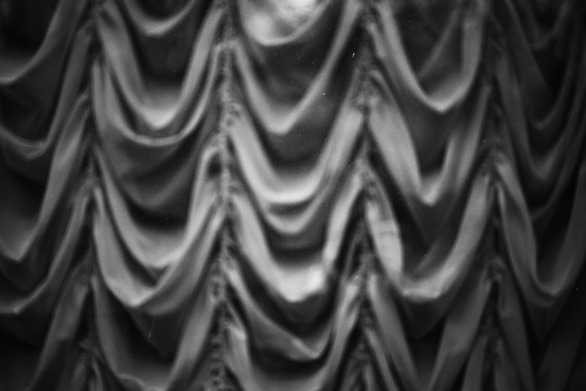Textured gray fabric with vertical folds related to Elegant Gray Swag Valance for Your Home Decor