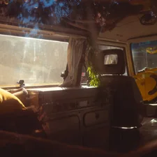 the interior of a camper van with the sun shining through the window related to The Ultimate Guide to VW Bus Beds