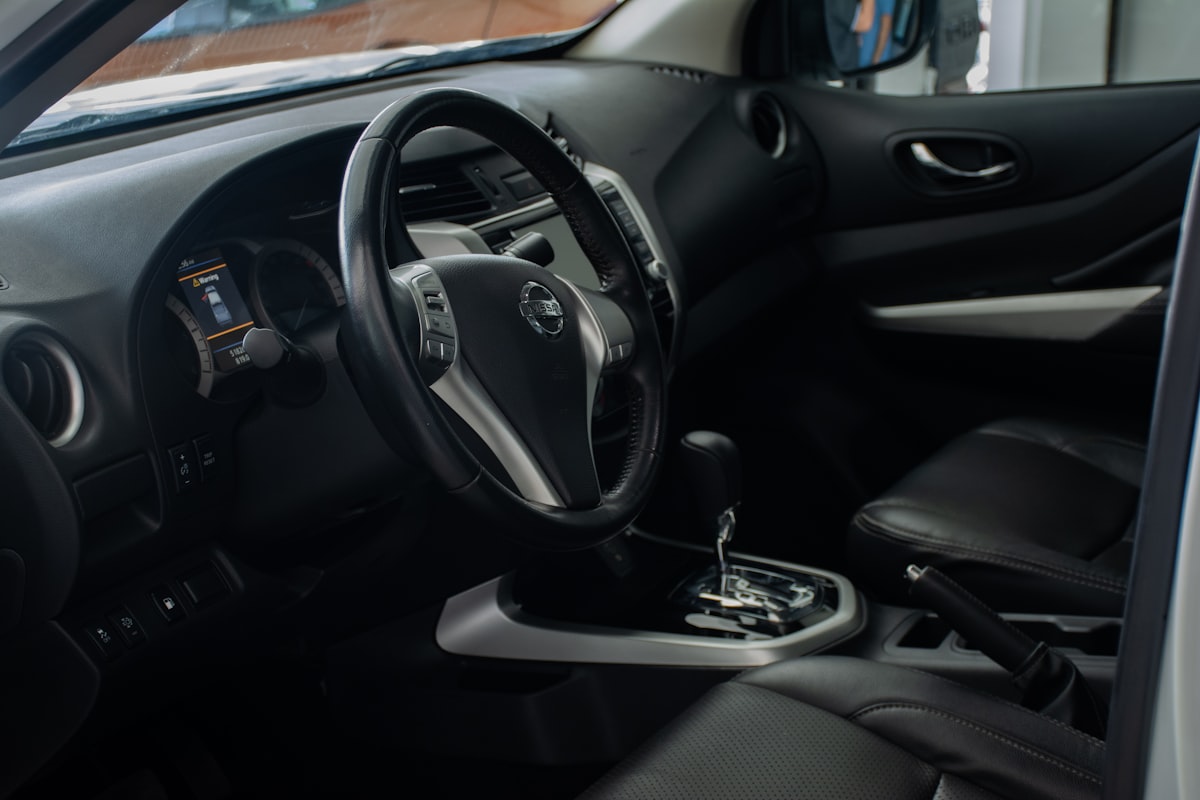 the interior of a car with a steering wheel and dashboard related to Enhance Your Nissan Frontier with the Right Bed Cover