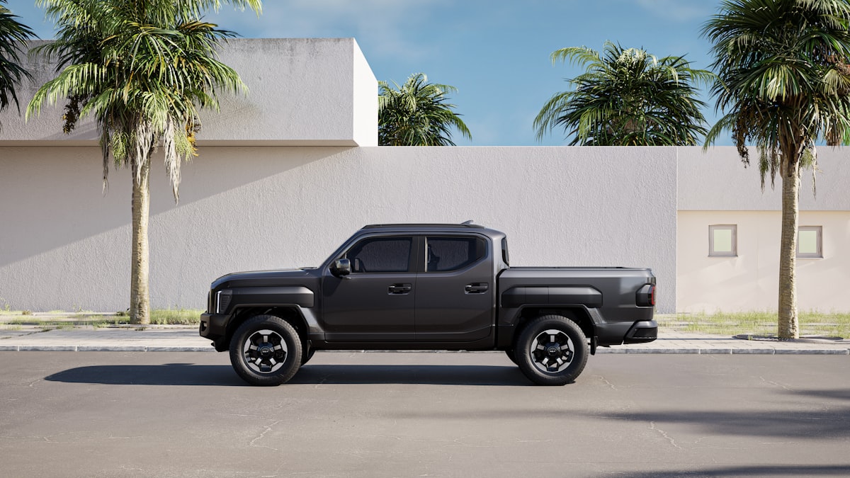 The left side view of the Kia Tasman parked in front of a building on a clear day. related to The Versatility and Advantages of Flat Bed Trucks
