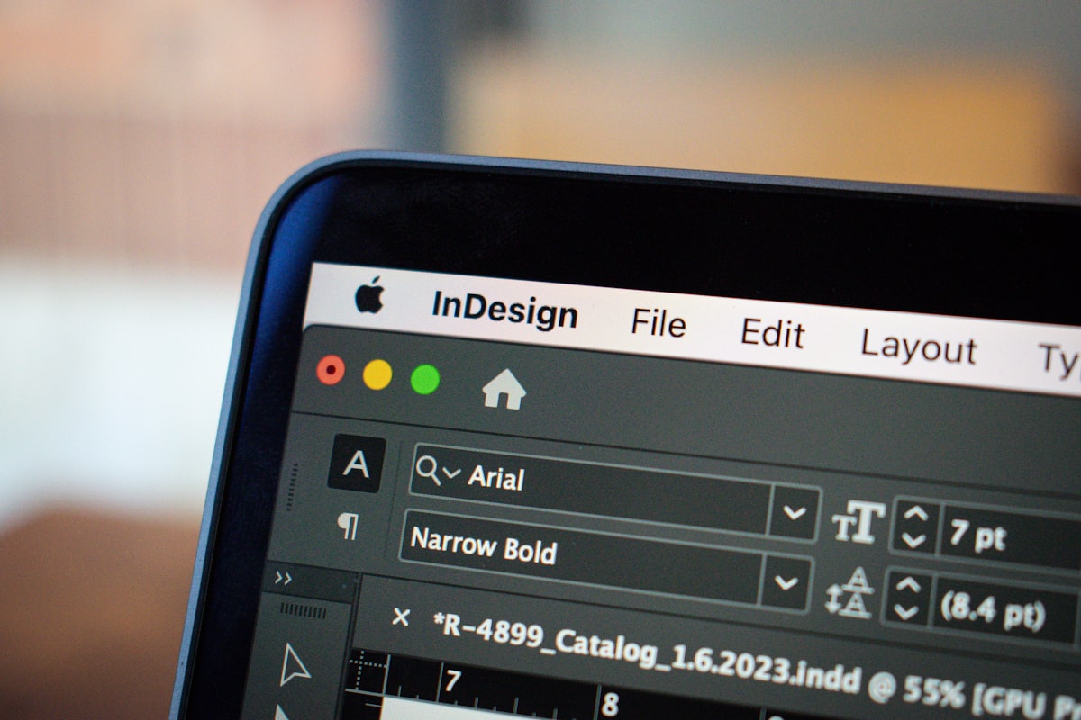 This close-up image showcases a MacBook Pro screen displaying an open project in Adobe InDesign. The focus is on the detailed interface of InDesign, with various design elements and toolbars visible, illustrating the software's functionality in graphic design and layout creation. The MacBook Pro's sleek design and high-resolution screen are highlighted, emphasizing the clarity and precision with which creative projects can be developed and viewed on this device. related to Add Style and Functionality to Your Home with Grommet Valance Curtains