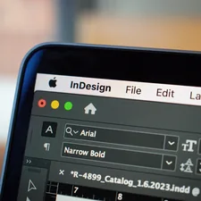 This close-up image showcases a MacBook Pro screen displaying an open project in Adobe InDesign. The focus is on the detailed interface of InDesign, with various design elements and toolbars visible, illustrating the software's functionality in graphic design and layout creation. The MacBook Pro's sleek design and high-resolution screen are highlighted, emphasizing the clarity and precision with which creative projects can be developed and viewed on this device. related to Add Style and Functionality to Your Home with Grommet Valance Curtains