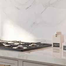 This collection of images showcases a stunning, high-end kitchen design that masterfully blends neo-classical architecture with modern luxury. The primary color palette is a soothing "greige" featured on the floor-to-ceiling cabinetry, accented by elegant brushed brass hardware. Central to the room is a large walnut-wood island topped with a thick, polished Calacatta marble slab, which is mirrored in the dramatic full-height backsplash. related to Elevate Your Kitchen Style: The Ultimate Guide to Waverly Kitchen Valances