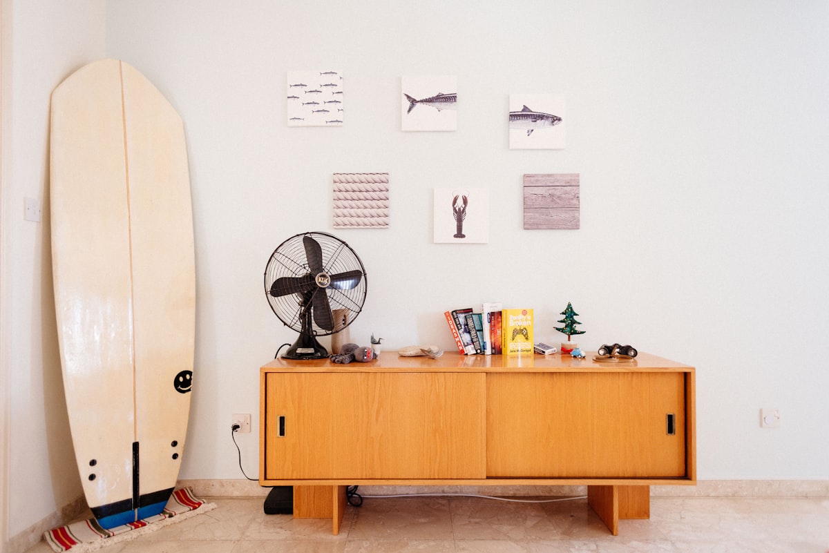 This is my place that i added on Airbnb & Booking (i named it: Family and Relax)

That is my first surfboard which was 8 foot and after crashing on a reef it became 7 foot :)

The fan is really old and belonged to my grandfather.

The wooden furniture, binoculars is pretty old and was in my uncles office until he retired.

Frames on the wall are from IKEA.

Books (Simplicity, Gamification, Reality is Broken, The hundred year old man that climb through the window and disappeared, Hero) related to The Ultimate Guide to Sideboards and Buffets
