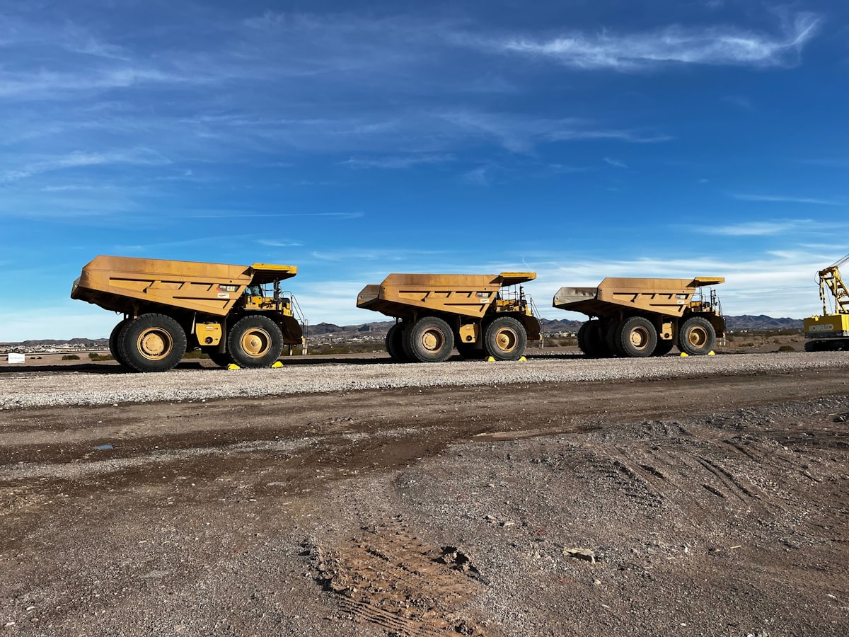 Three Caterpillar 777G mining haul trucks at work in Nevada. related to The Importance of Dump Truck Sideboards: Elevating Your Construction Experience